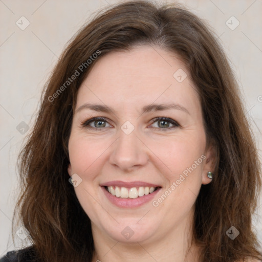 Joyful white adult female with long  brown hair and brown eyes