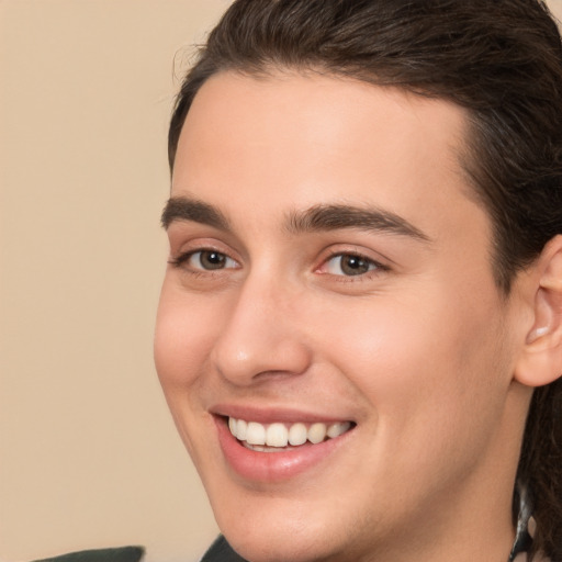 Joyful white young-adult male with medium  brown hair and brown eyes