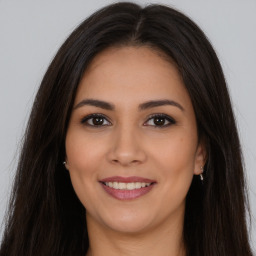 Joyful white young-adult female with long  brown hair and brown eyes