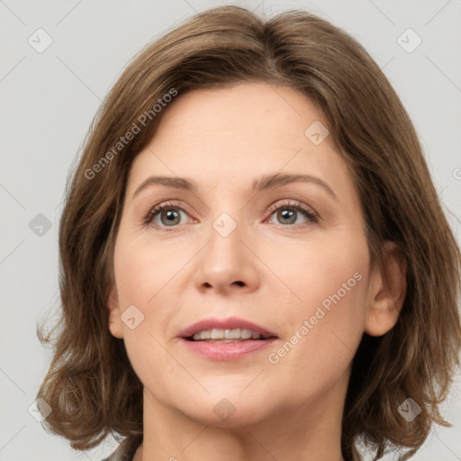 Joyful white adult female with medium  brown hair and green eyes