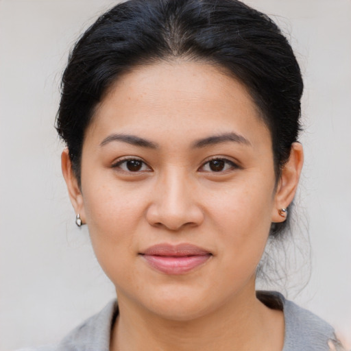 Joyful latino young-adult female with medium  brown hair and brown eyes