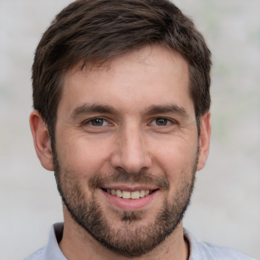 Joyful white young-adult male with short  brown hair and brown eyes