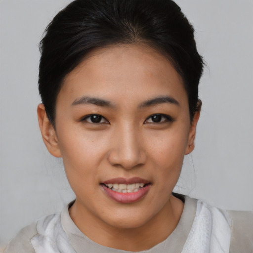 Joyful asian young-adult female with short  brown hair and brown eyes
