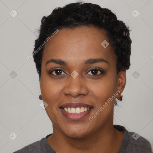 Joyful black young-adult female with short  black hair and brown eyes