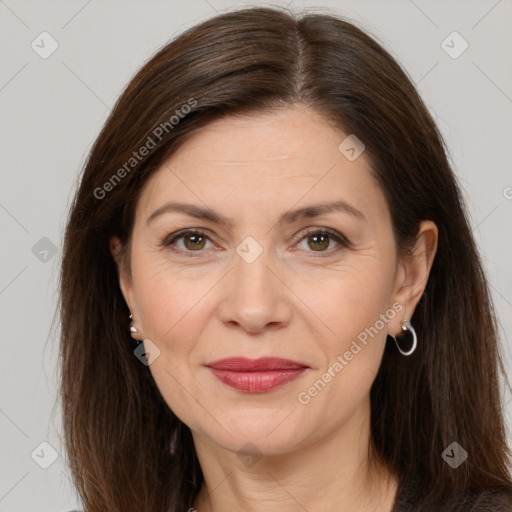 Joyful white adult female with long  brown hair and brown eyes