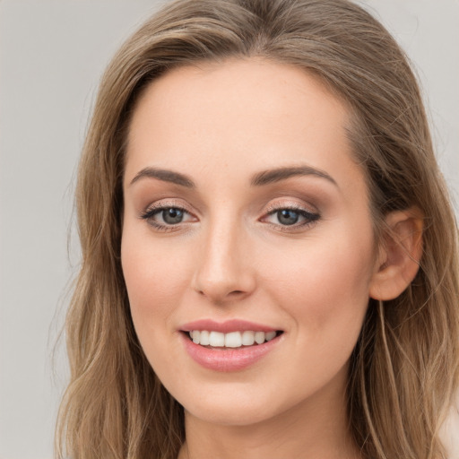 Joyful white young-adult female with long  brown hair and grey eyes