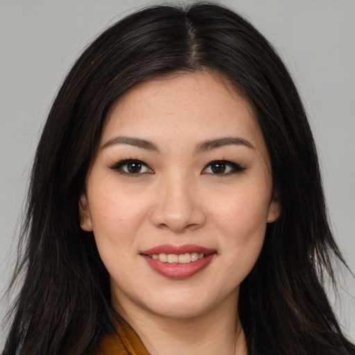 Joyful asian young-adult female with long  brown hair and brown eyes