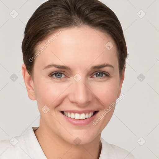 Joyful white young-adult female with short  brown hair and grey eyes