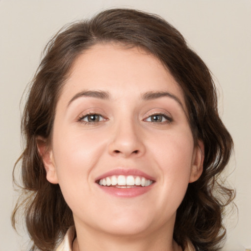 Joyful white young-adult female with medium  brown hair and blue eyes