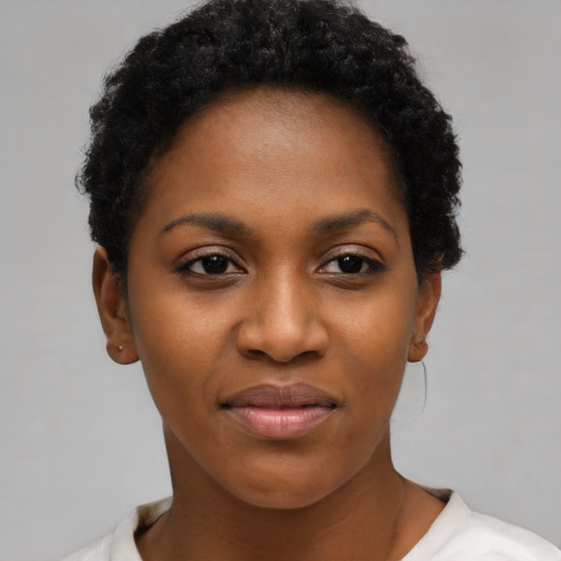 Joyful black young-adult female with short  brown hair and brown eyes