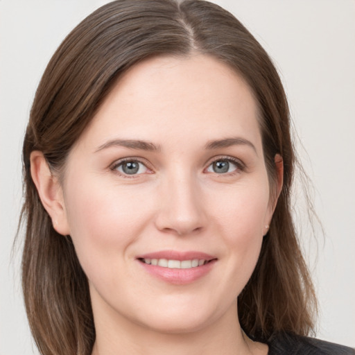 Joyful white young-adult female with long  brown hair and grey eyes