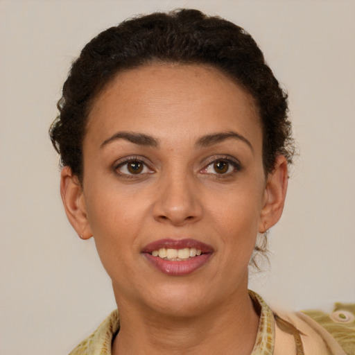 Joyful latino young-adult female with short  brown hair and brown eyes