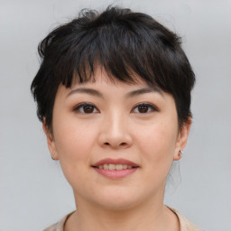 Joyful asian young-adult female with short  brown hair and brown eyes