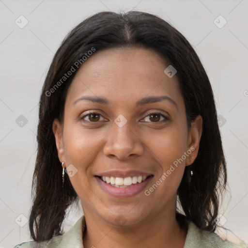 Joyful black young-adult female with long  brown hair and brown eyes