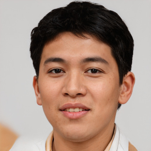 Joyful asian young-adult male with short  brown hair and brown eyes