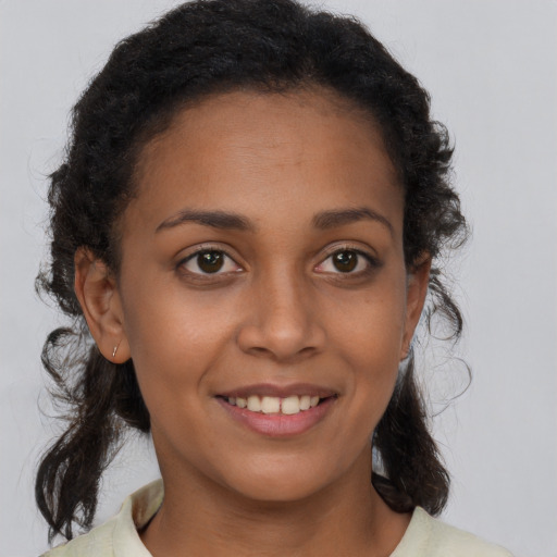 Joyful latino young-adult female with medium  brown hair and brown eyes