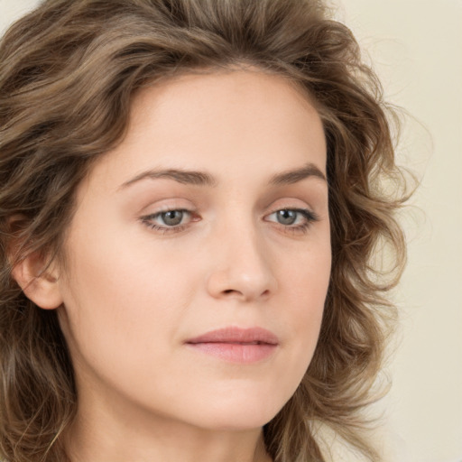 Joyful white young-adult female with long  brown hair and green eyes