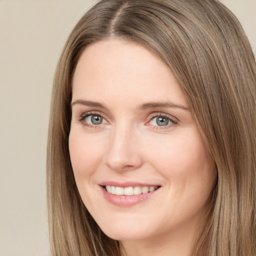 Joyful white young-adult female with long  brown hair and brown eyes