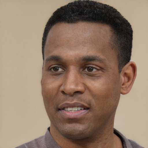 Joyful latino adult male with short  black hair and brown eyes