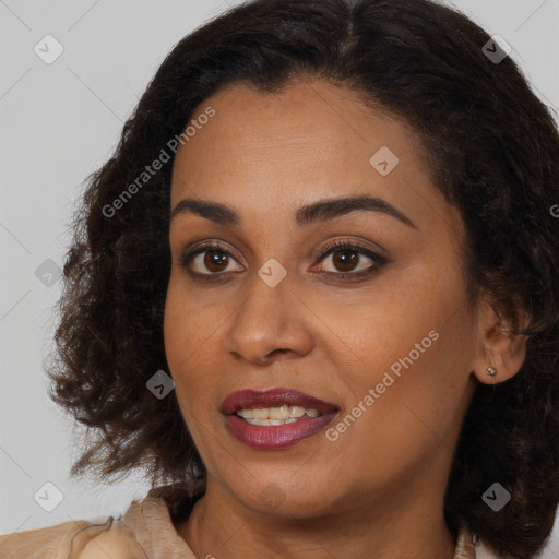 Joyful black young-adult female with long  brown hair and brown eyes