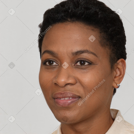 Joyful black young-adult female with short  black hair and brown eyes