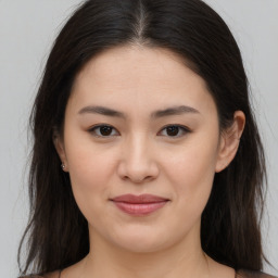 Joyful asian young-adult female with long  brown hair and brown eyes