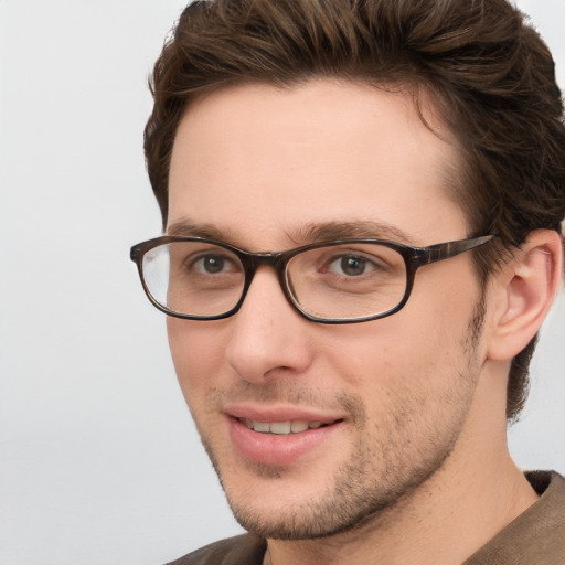 Joyful white young-adult male with short  brown hair and blue eyes