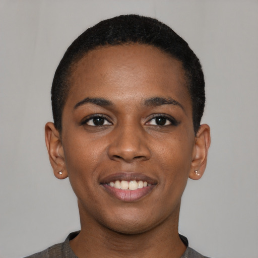 Joyful black young-adult female with short  black hair and brown eyes