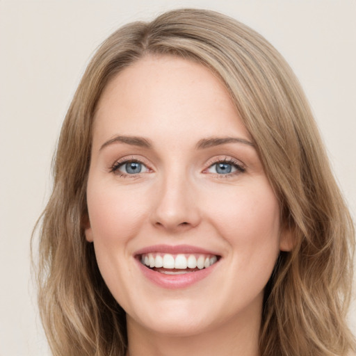 Joyful white young-adult female with long  brown hair and green eyes