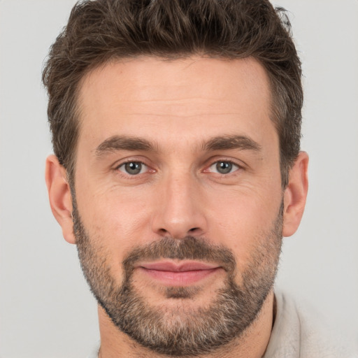 Joyful white adult male with short  brown hair and brown eyes