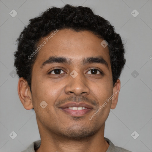 Joyful black young-adult male with short  brown hair and brown eyes