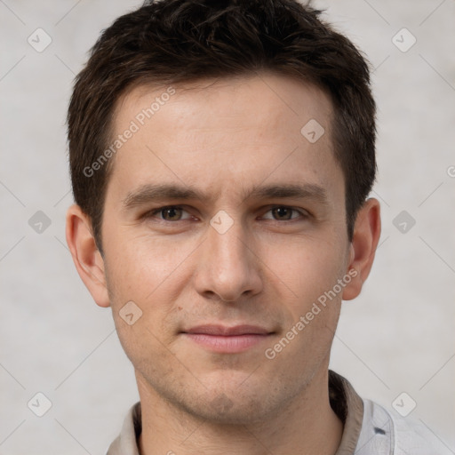 Joyful white young-adult male with short  brown hair and grey eyes