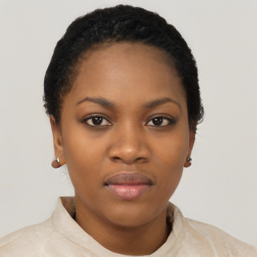 Joyful black young-adult female with short  black hair and brown eyes