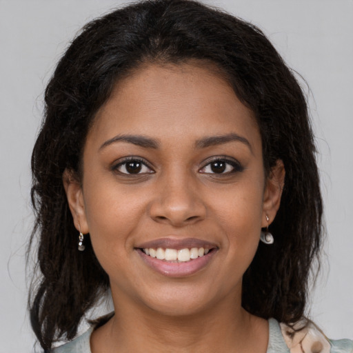Joyful black young-adult female with medium  brown hair and brown eyes