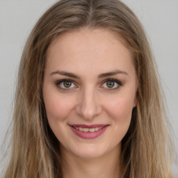 Joyful white young-adult female with long  brown hair and green eyes