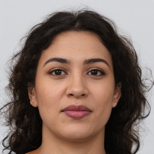 Joyful latino young-adult female with long  brown hair and brown eyes