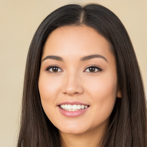 Joyful latino young-adult female with long  black hair and brown eyes