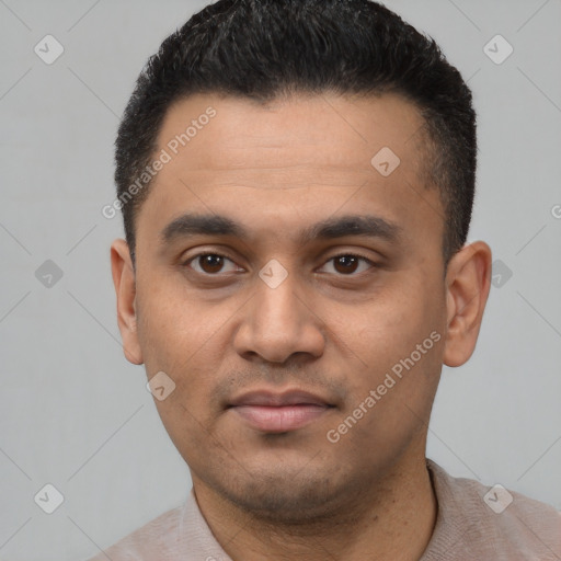 Joyful latino young-adult male with short  black hair and brown eyes