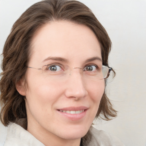 Joyful white adult female with medium  brown hair and blue eyes