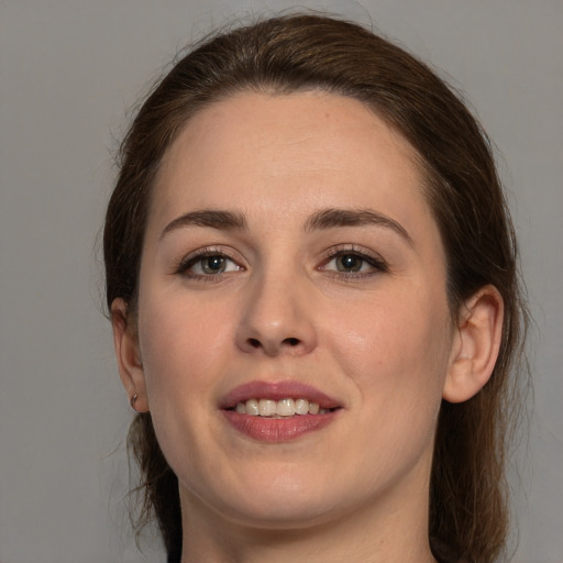 Joyful white young-adult female with medium  brown hair and brown eyes