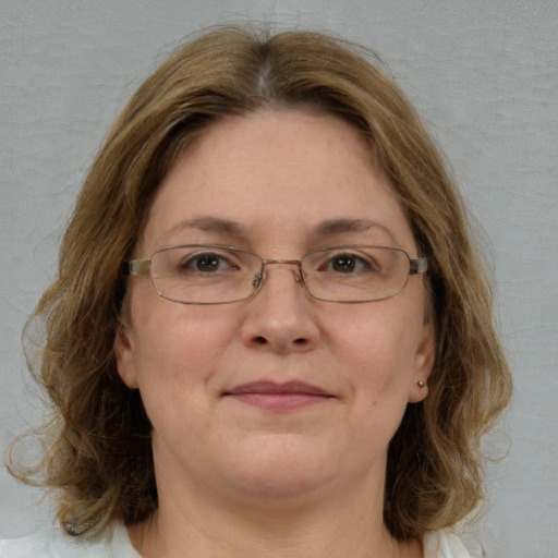 Joyful white adult female with medium  brown hair and blue eyes