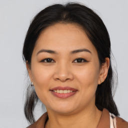 Joyful asian young-adult female with medium  brown hair and brown eyes