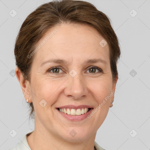 Joyful white adult female with short  brown hair and grey eyes