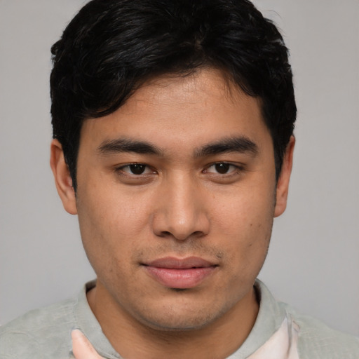 Joyful asian young-adult male with short  black hair and brown eyes