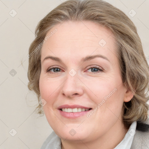 Joyful white adult female with medium  brown hair and blue eyes