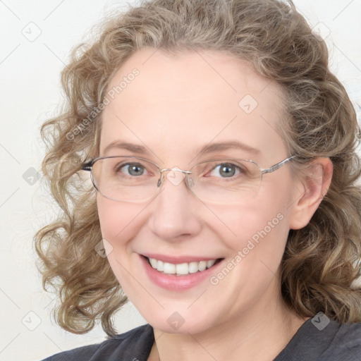 Joyful white adult female with medium  brown hair and blue eyes