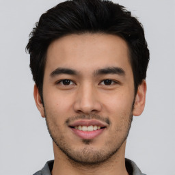 Joyful asian young-adult male with short  black hair and brown eyes