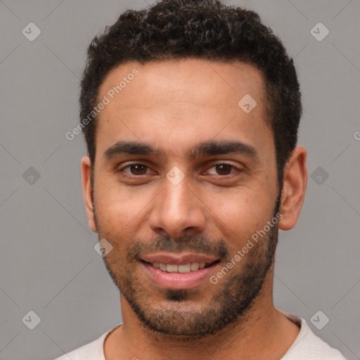 Joyful white young-adult male with short  black hair and brown eyes