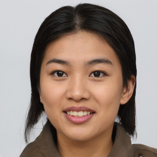 Joyful asian young-adult female with long  black hair and brown eyes