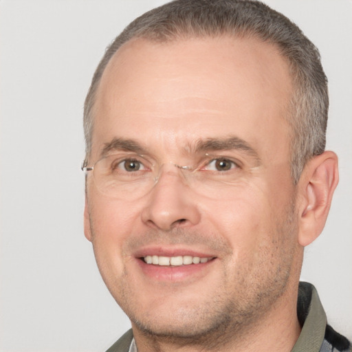 Joyful white adult male with short  brown hair and brown eyes